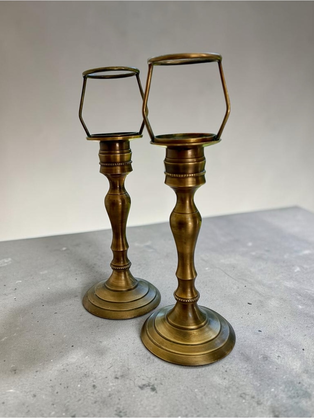 Nate Berkus brass candle holders, with geometric hurricane frames, brushed look